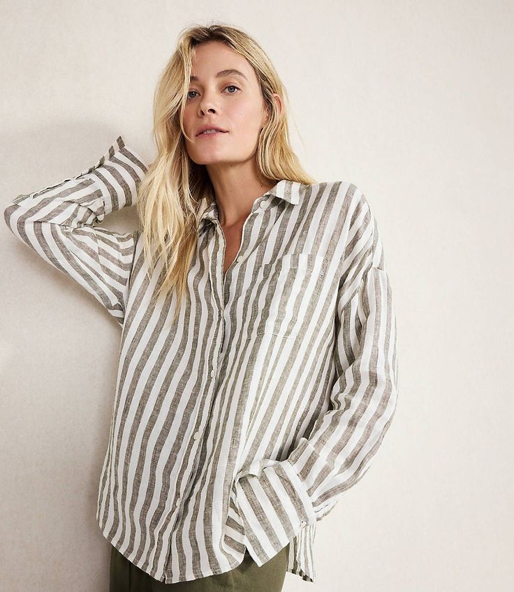 Woman with long blonde hair wearing a striped shirt indoors