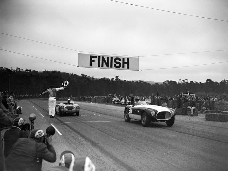 Vintage car race with a checkered flag waving at the finish line