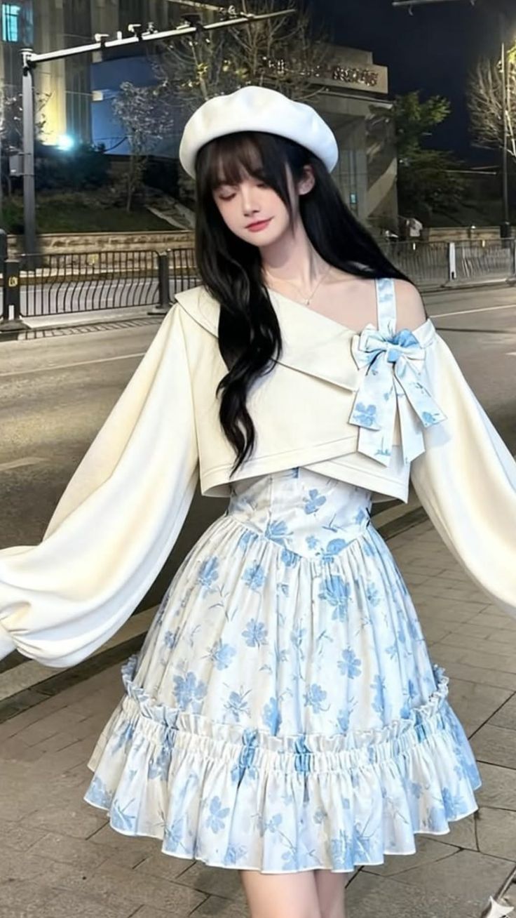 Woman in a white beret and floral dress with a blue bow at night