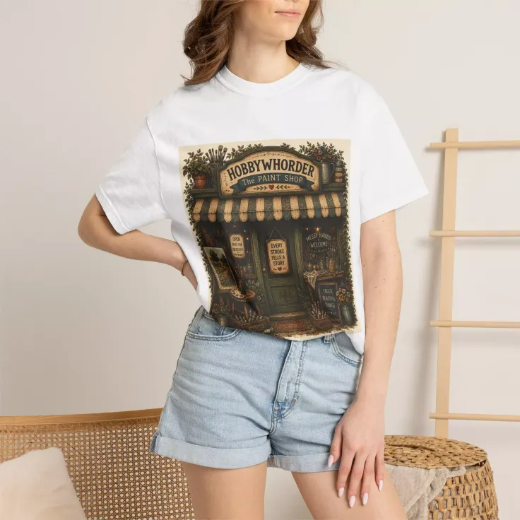Woman in a white t-shirt with a shop graphic and denim shorts