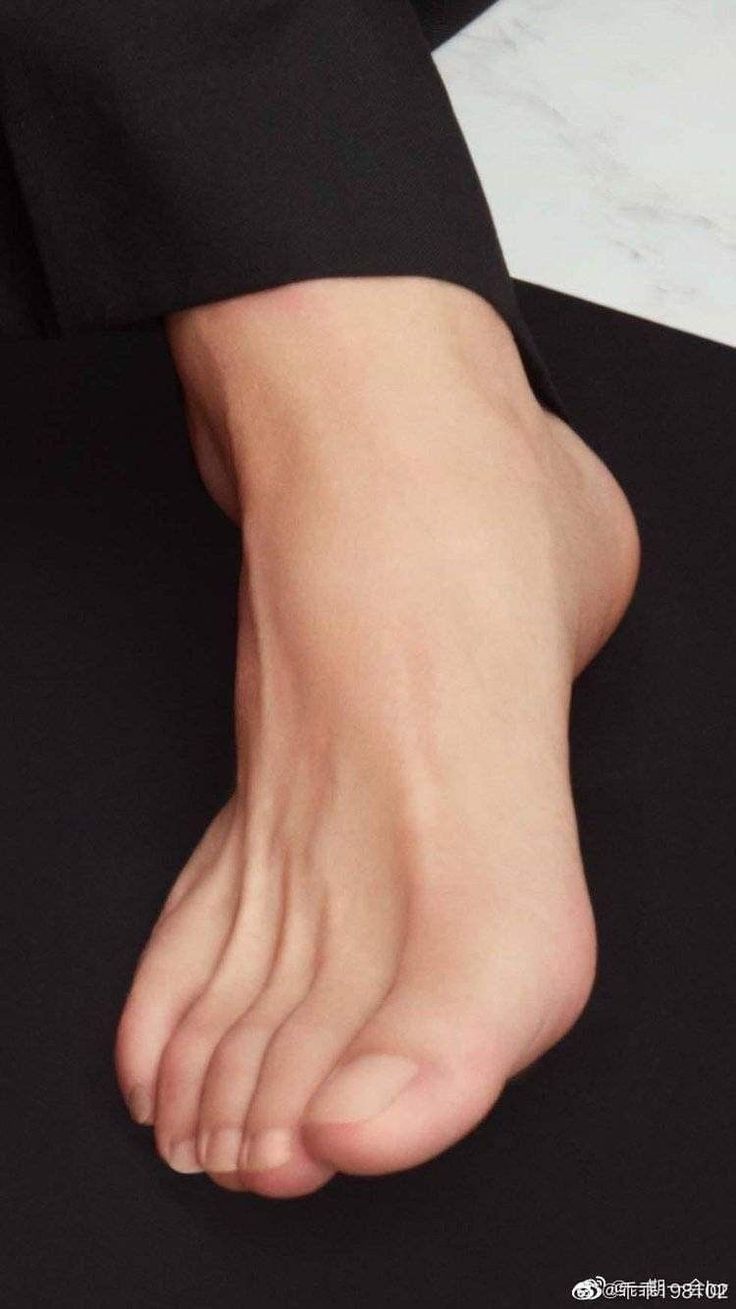 Close up of a bare foot against a dark background