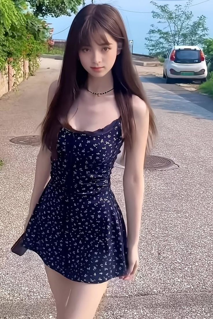 Woman with long hair wearing a floral dress and choker on a street