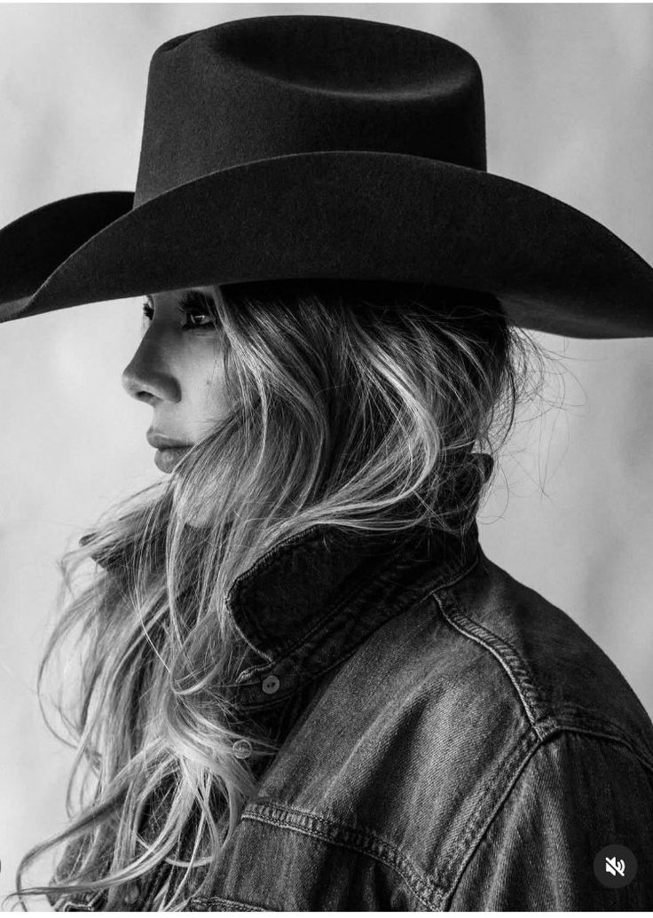 Woman in a cowboy hat and denim jacket in black and white