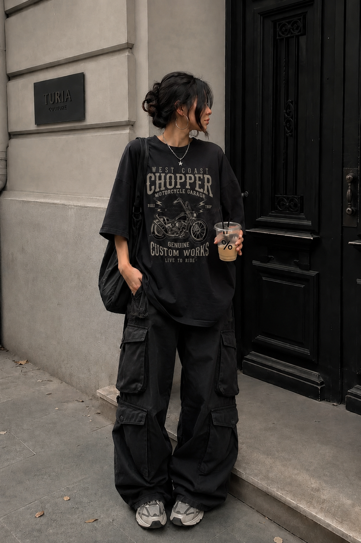 Person in an oversized t-shirt and cargo pants standing on a street
