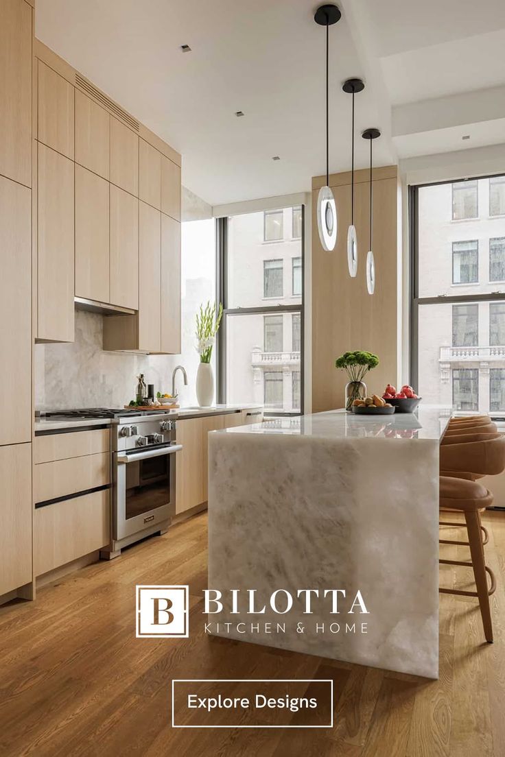 Modern kitchen with light wood cabinets, marble island, and cityscape view