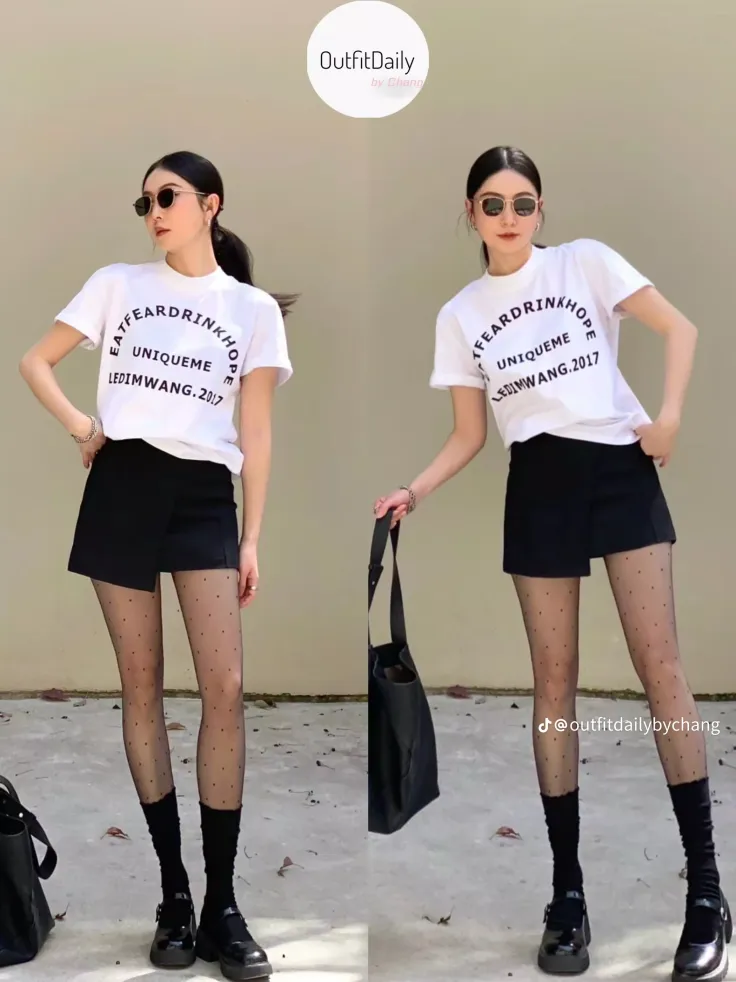 Woman in a white t-shirt, black skirt, and polka dot tights posing outdoors