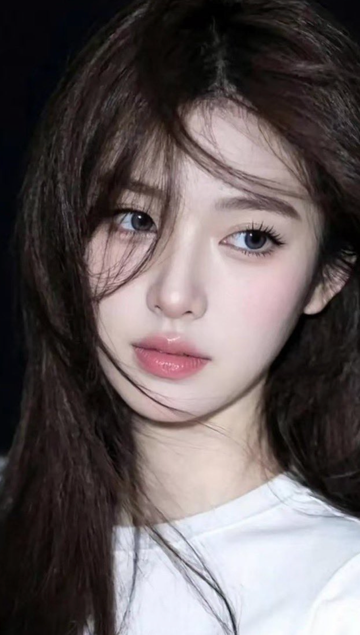 Close up portrait of a woman with long dark hair and pink lips