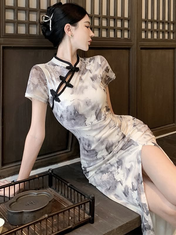 Woman in a patterned cheongsam dress with a high slit and updo hair