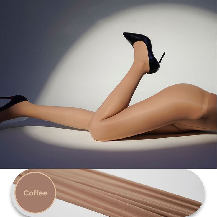 Legs in pantyhose and high heels in a provocative pose under a spotlight
